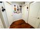 Hallway displaying the lovely wood flooring, decorative art pieces, and the bright white doors with silver hardware throughout at 1842 Ridgelake Ct, Wesley Chapel, FL 33543