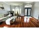 Bright and airy living room with hardwood floors, large windows, and stylish furniture at 1842 Ridgelake Ct, Wesley Chapel, FL 33543