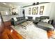 Spacious living room with a comfortable sectional sofa, area rug, and views into the kitchen at 1842 Ridgelake Ct, Wesley Chapel, FL 33543