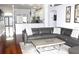 Inviting living room with a large sectional sofa, area rug, and views into the kitchen at 1842 Ridgelake Ct, Wesley Chapel, FL 33543