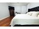 Spacious main bedroom featuring hardwood floors, tv, and a dedicated workspace at 1842 Ridgelake Ct, Wesley Chapel, FL 33543