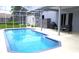Spacious screened-in pool area with outdoor seating, a grill, and storage at 1842 Ridgelake Ct, Wesley Chapel, FL 33543