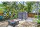 Backyard with seating area, storage shed, and decorative fence at 2051 Indigo Dr, Clearwater, FL 33763