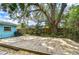 Spacious wooden deck in a private backyard with mature trees, ideal for entertaining and relaxation at 2051 Indigo Dr, Clearwater, FL 33763