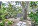 Backyard featuring a seating area, stepping stone path, and a storage shed at 2051 Indigo Dr, Clearwater, FL 33763