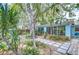 Lush backyard featuring a stepping stone path and tropical landscaping at 2051 Indigo Dr, Clearwater, FL 33763