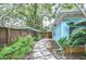 Backyard featuring a stepping stone path alongside the home's exterior at 2051 Indigo Dr, Clearwater, FL 33763