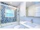 Bathroom featuring decorative tile, shower with glass doors, and modern vanity at 2051 Indigo Dr, Clearwater, FL 33763