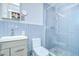 Nicely tiled bathroom with walk-in shower, vanity, and ample lighting at 2051 Indigo Dr, Clearwater, FL 33763