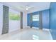 Bedroom featuring two windows with curtains, a ceiling fan, and modern paint at 2051 Indigo Dr, Clearwater, FL 33763