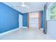 Bedroom featuring a bright blue wall, a ceiling fan and closet with louvered doors at 2051 Indigo Dr, Clearwater, FL 33763