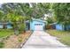Inviting blue home with a well-maintained driveway, tropical landscaping, and a cozy curb appeal at 2051 Indigo Dr, Clearwater, FL 33763