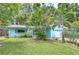 Charming light-blue single-story home with beautiful landscaping and a well-manicured lawn at 2051 Indigo Dr, Clearwater, FL 33763
