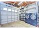 Bright and organized garage features updated shelving, laundry equipment, and plenty of room for storage at 2051 Indigo Dr, Clearwater, FL 33763