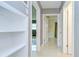 Hallway with built-in shelves, access to rooms, and neutral wall colors at 2051 Indigo Dr, Clearwater, FL 33763