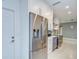 Modern kitchen with stainless steel refrigerator and white cabinets in a renovated home at 2051 Indigo Dr, Clearwater, FL 33763