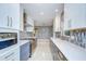 Updated kitchen featuring stainless appliances, white cabinets, and a unique backsplash design at 2051 Indigo Dr, Clearwater, FL 33763