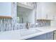 Close-up of the kitchen sink, quartz countertop, and modern tile backsplash at 2051 Indigo Dr, Clearwater, FL 33763
