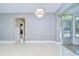Open living room featuring refinished flooring, natural light and modern lighting fixture at 2051 Indigo Dr, Clearwater, FL 33763