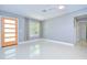 Spacious living room featuring a modern door, sleek floors, and neutral paint colors at 2051 Indigo Dr, Clearwater, FL 33763