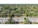 Aerial view showing the community townhomes surrounded by lush greenery and mature trees at 2248 Lake Woodberry Cir, Brandon, FL 33510