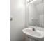 Clean powder room featuring a white pedestal sink, a large mirror, and neutral decor at 2248 Lake Woodberry Cir, Brandon, FL 33510