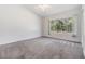 Bright bedroom with a large window offering scenic outdoor views and ample natural light at 2248 Lake Woodberry Cir, Brandon, FL 33510