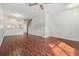 Open-concept living space with hardwood floors, stairs, and a view of the kitchen for modern living at 2248 Lake Woodberry Cir, Brandon, FL 33510