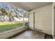 Enclosed patio features view of backyard, wall-mounted light and access door to property's backyard at 2248 Lake Woodberry Cir, Brandon, FL 33510