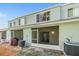 View of the home's rear exterior, featuring a screened lanai and multiple windows at 2248 Lake Woodberry Cir, Brandon, FL 33510