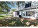 View of backyard with lawn, patio, vinyl fence and mature shade trees at 2316 Lake Woodberry Cir, Brandon, FL 33510