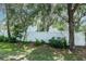 Backyard with vinyl fence, lush landscaping and a grass lawn at 2316 Lake Woodberry Cir, Brandon, FL 33510