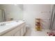 Bright bathroom features a double sink vanity and a shelf for decorative storage at 2316 Lake Woodberry Cir, Brandon, FL 33510