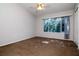 Bedroom with large window, neutral walls, and ceiling fan offering ample natural light at 2316 Lake Woodberry Cir, Brandon, FL 33510