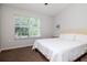 Cozy bedroom featuring a queen-size bed, and a large window with natural light at 2316 Lake Woodberry Cir, Brandon, FL 33510