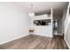 Open-concept dining area with laminate floors and modern chandelier at 2316 Lake Woodberry Cir, Brandon, FL 33510