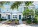 Inviting townhome showcasing a well-maintained facade and lovely landscaped front yard at 2316 Lake Woodberry Cir, Brandon, FL 33510