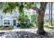 Charming townhome featuring lush greenery and mature trees surrounding the property at 2316 Lake Woodberry Cir, Brandon, FL 33510