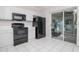 Efficient kitchen featuring white cabinets, and sleek black appliances at 2316 Lake Woodberry Cir, Brandon, FL 33510