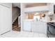 Kitchen view, showing white cabinets, black appliances, and a glimpse of the staircase at 2316 Lake Woodberry Cir, Brandon, FL 33510