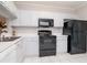 Bright kitchen featuring white cabinets, laminate flooring, and modern appliances at 2316 Lake Woodberry Cir, Brandon, FL 33510