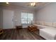 Cozy living room featuring a large window and stylish laminate flooring at 2316 Lake Woodberry Cir, Brandon, FL 33510