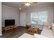 Comfortable living area with neutral tones, laminate flooring, and plenty of natural light at 2316 Lake Woodberry Cir, Brandon, FL 33510