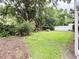 Manicured backyard with a lush lawn, mature trees, privacy fence, and landscaping at 2523 Krueger Lane, Tampa, FL 33618