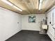 Unfinished basement with a window, laundry sink, rubber flooring, and an exposed wood ceiling at 2523 Krueger Lane, Tampa, FL 33618
