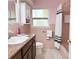 Charming bathroom featuring a granite vanity, window, and white cabinet providing ample storage at 2523 Krueger Lane, Tampa, FL 33618