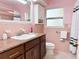 Charming bathroom featuring a granite vanity, window, and white cabinet providing ample storage at 2523 Krueger Lane, Tampa, FL 33618