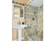 Updated bathroom with a pedestal sink and a tiled shower with niche at 2523 Krueger Lane, Tampa, FL 33618