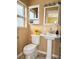 Cozy bathroom with pedestal sink, toilet, medicine cabinet and bright yellow accents at 2523 Krueger Lane, Tampa, FL 33618