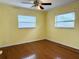 Bright bedroom with hardwood floors and two windows offering natural light at 2523 Krueger Lane, Tampa, FL 33618